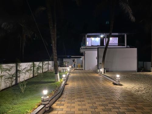 a walkway leading to a building at night at Rock n Ocean2 , Beach stay in Udupi