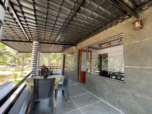 an outdoor dining area with a table and chairs at Rock n Ocean2 , Beach stay in Udupi