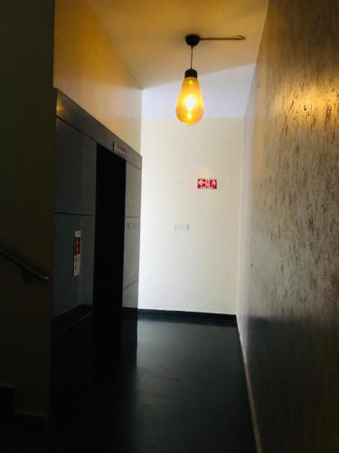 an empty hallway with a light hanging from a ceiling at Astra Hotels & Suites - HSR Layout Sector 1, Near Ecospace Bellandur in Bengaluru
