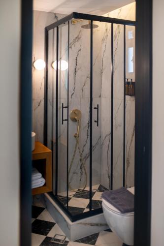 a bathroom with a shower with a toilet in it at Aggelos Hotel in Alexandroupoli