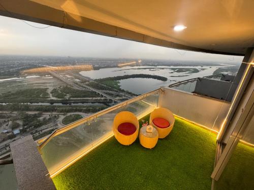 a view from the top of a building with two chairs at Spira supernova in New Delhi