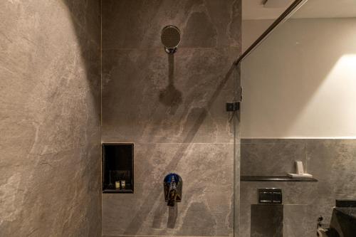 a shower with a shower head in a bathroom at Chalston Beach Resort in Calangute