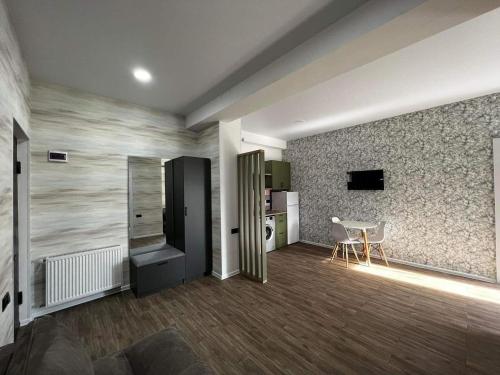 a living room with a table and a kitchen at My Sweet Home in Rustavi city 9 in Rustavi