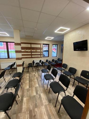 a waiting room with chairs and a flat screen tv at Alpin Borovets, Алпин Боровец in Borovets