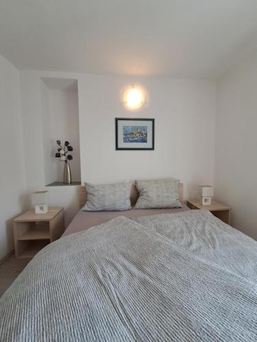 a bedroom with a large bed and two night stands at Greta in Vrbnik