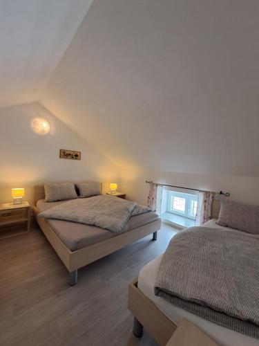 a bedroom with two beds and a window at Greta in Vrbnik