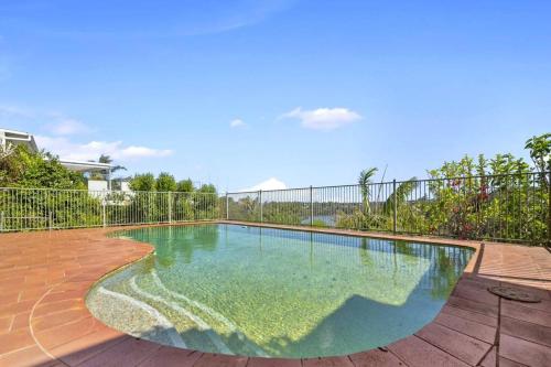 a swimming pool with a fence around it at River View Oasis: Spacious 3-Bed House with Pool in Sydney