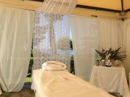 a room with a bed and a window with curtains at Hotel Holiday Sul Lago in Bolsena