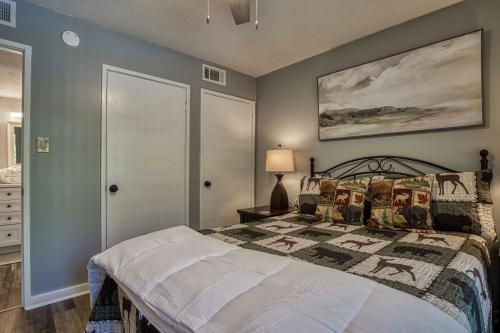 a bedroom with a bed and a painting on the wall at Newly Renovated 5 Star Condo, Pool, Gorgeous View in Sevierville