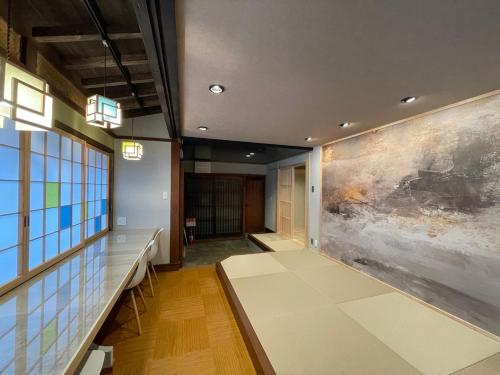 a hallway with a large painting on the wall at 游　別邸　飛騨高山　狐福 in Takayama