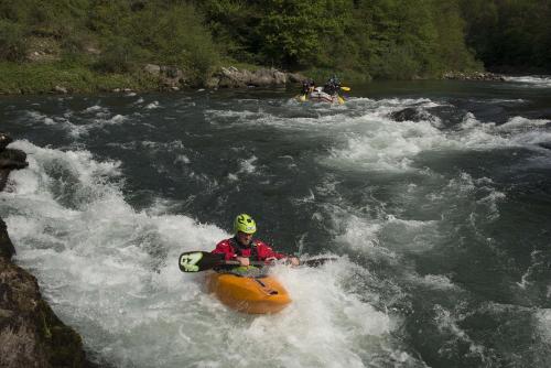 a person in an orange raft in a river at Bes Hotel Papa San Pellegrino Terme in San Pellegrino Terme