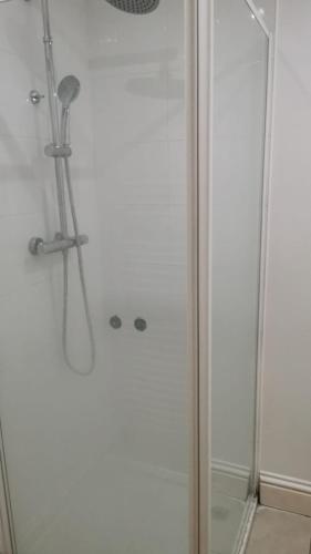 a shower with a glass door in a bathroom at Deluxe Double Room Cosy and Comfortable FFDBL7 in Barking
