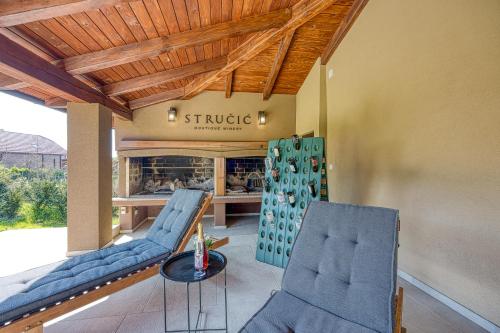 a store with blue chairs and a table in a room at Hedonistic Vineyard Estate With Hot Tub - Happy Rentals in Ludbreg