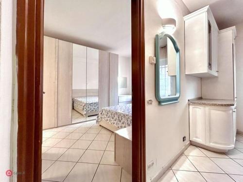 una camera con letto e specchio di Appartamento centrale a Tortona