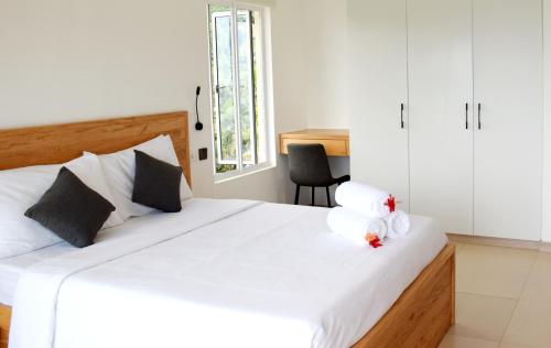 a bedroom with a bed with a stuffed animal on it at Lagati Self-Catering Seychelles in Mahe