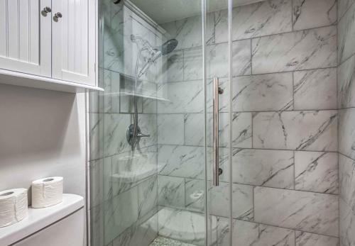a bathroom with a shower with a glass door at Newly Renovated 5 Star Condo, Pool, Gorgeous View in Sevierville