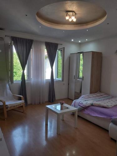 a bedroom with a bed and a coffee table at Central Comfort Apartment 5 Minute Walk to Beach, Free Parking, 2 BR in Struga