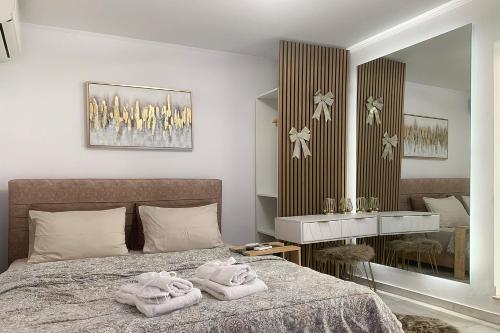 a bedroom with a bed with towels on it at Stunning Panoramic Athens view, 2 minutes metro in Athens