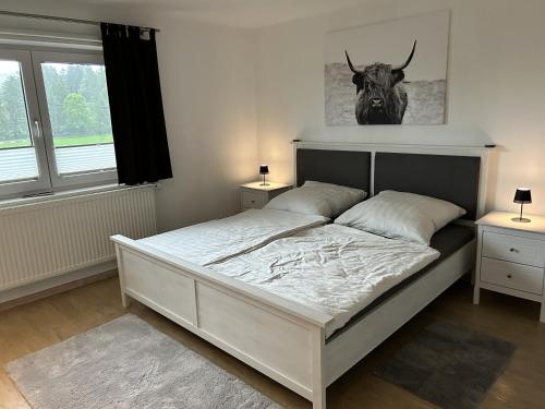 a bedroom with a bed with a bull head on the wall at Ferienhaus Frank Grieser in Hopferau
