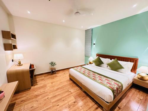 a hotel room with a bed and a table and a desk at Hotel IP Swarn near Anand Vihar Vaishali Ghaziabad in Ghaziabad
