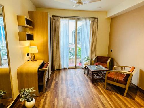 a living room with a couch and a table at Hotel IP Swarn near Anand Vihar Vaishali Ghaziabad in Ghaziabad