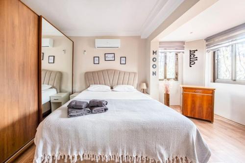 a bedroom with a large bed with two towels on it at Arya Roof House in Marmaris