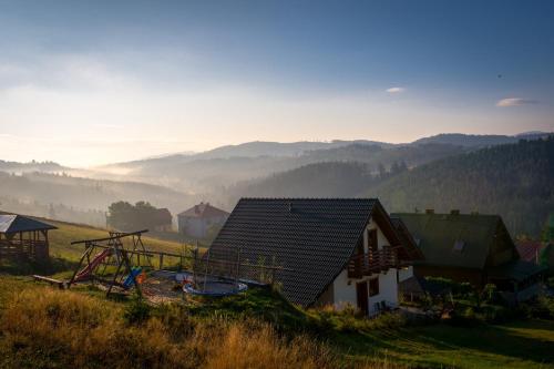 a house on a hill with a view of the mountains at Domek u Małysza Istebna in Istebna