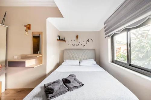 a bedroom with a white bed with towels on it at Arya Roof House in Marmaris