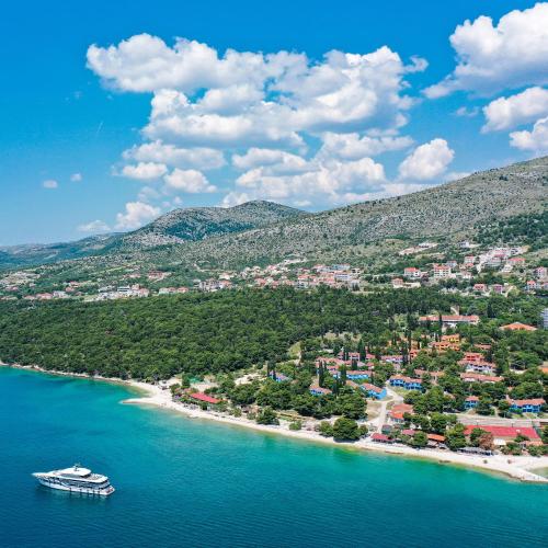 an aerial view of a beach with a boat in the water at Apartments Medena in Trogir