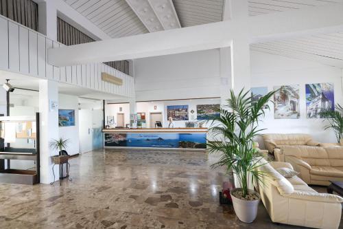 a large living room with couches and plants at Apartments Medena in Trogir