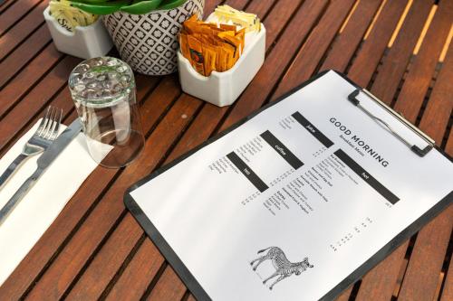 a table with a menu on top of a table at Zebra Motel in Coffs Harbour