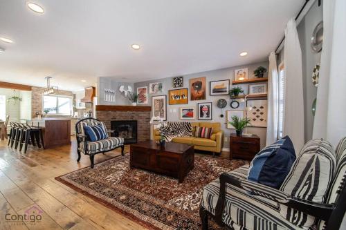 a living room with a couch and a fireplace at Stylish Euro Vibes Home, Small Gym, AC, Yard, Office in Edmonton