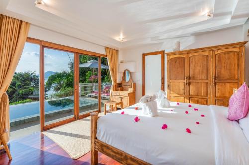 a bedroom with a bed with roses on it at Soul Villas by The Beach - Phuket in Panwa Beach