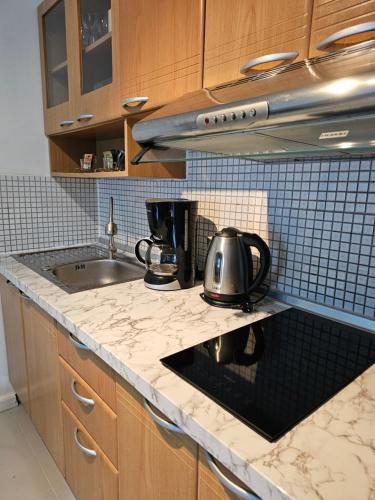 a kitchen with a sink and a counter top at Patong Tower Apartment in Patong Beach