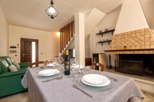 a table with plates and wine glasses on it at Appartamento Libio Porto Torres in Porto Torres