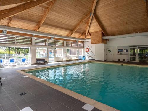 a large swimming pool in a building at Holiday home Club Le Domaine Du Golf 2 in Saint-Hilaire-Saint-Florent