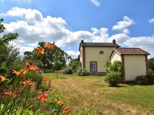 a small house in a yard with flowers at Modern holiday home in Crux La Ville with terrace in Crux-la-Ville