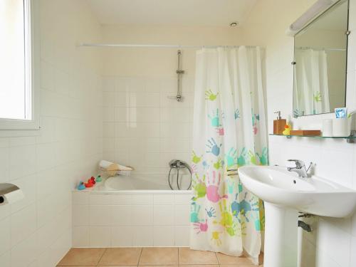 baño con lavabo y cortina de ducha en Villa Domaine Les Forges 1 en Les Forges
