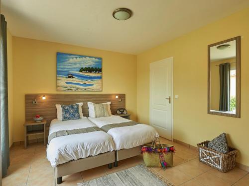 a bedroom with a bed and a painting on the wall at Luxe villa in Les Forges with BBQ Garden in Les Forges