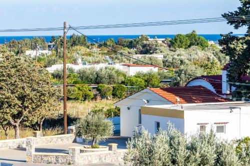 a white house with a view of the ocean at Villa Maroula in Afantou
