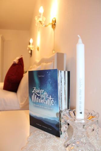 a book sitting on a table next to a candle at ZumGlückFrei in Passau
