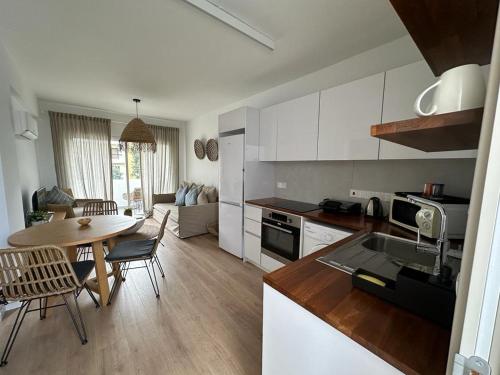 a kitchen and living room with a table and chairs at KSQUARED in Protaras