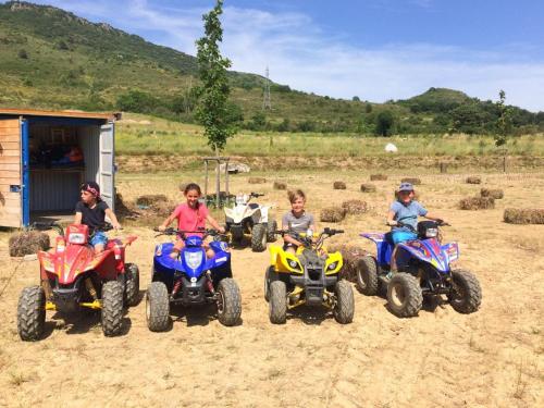 a group of children riding atvs on a dirt field at Holiday Home in Quillan near Pyrenees in Quillan