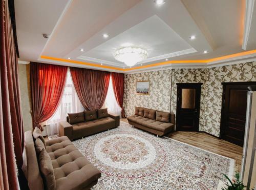 a living room with two couches and a fireplace at Гостевой дом Рамазан-отель in Taraz