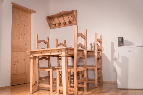 a wooden table and chairs in a room with a refrigerator at Austria Parks - Leutasch in Leutasch