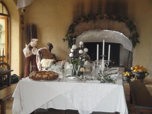 a table with a white table cloth and food on it at Distinctive tiny house in Sarrians with terrace in Sarrians