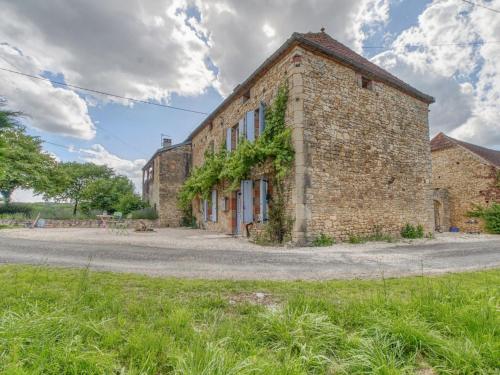 an old brick building with ivy growing on it at Alluring Holiday Home in D gagnac with Heated Pool in Dégagnac