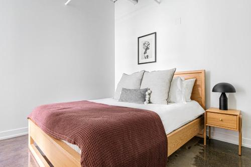 a bedroom with a wooden bed with a red blanket at Uptown 1BR w Gym Rooftop Pool 2 blocks to L CHI-383 in Chicago