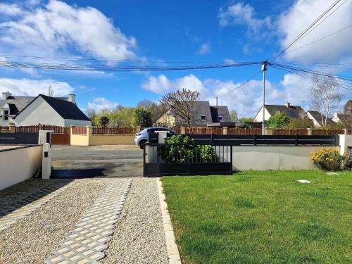 a house with a car parked in a driveway at Holiday Home near Val-André Beach & Golf in Saint-Alban