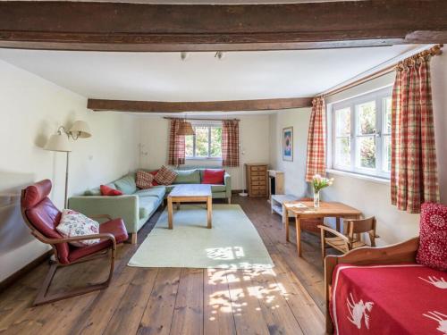 a living room with a couch and a table at Holiday home gardener's house in Unsleben